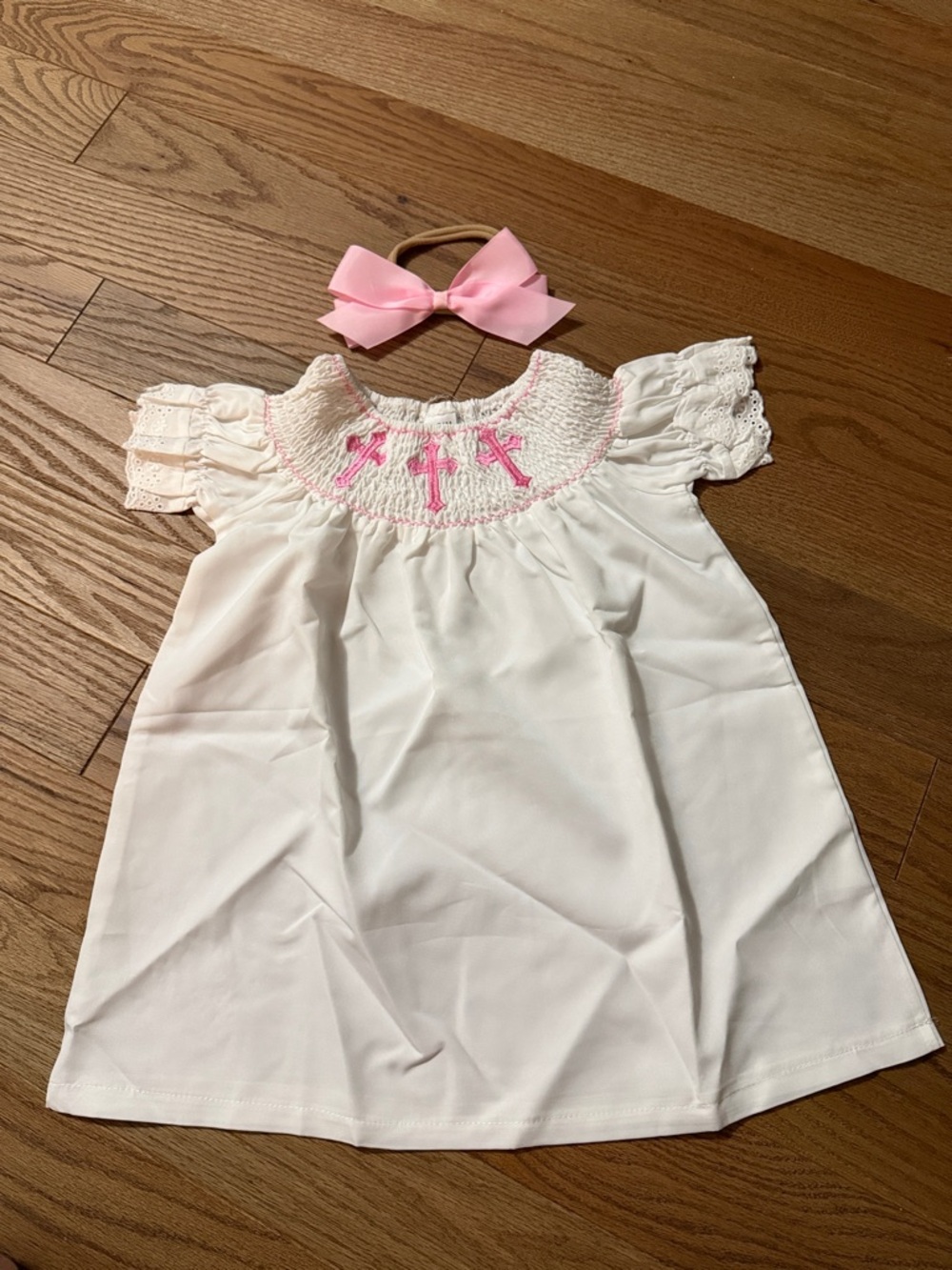 White Smocked Baby Dress with Pink Cross Embroidery and Bow